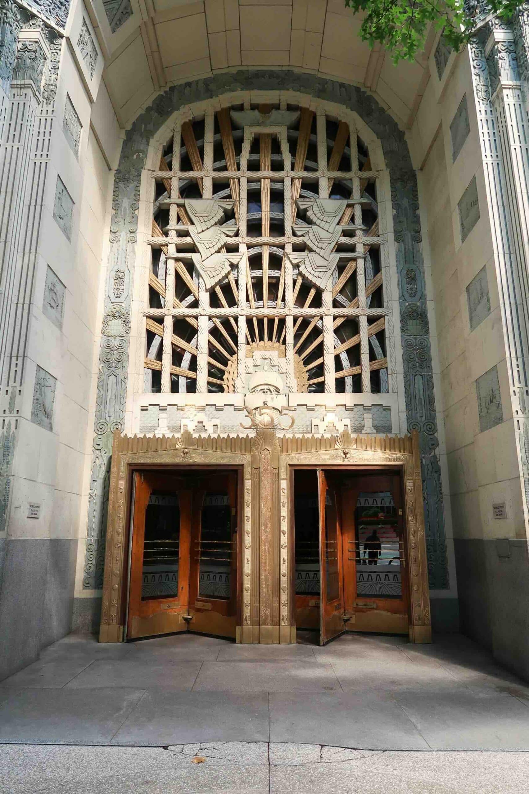 Marine Building entrance with a tall decorated surround and radiating metalwork above the doors.
